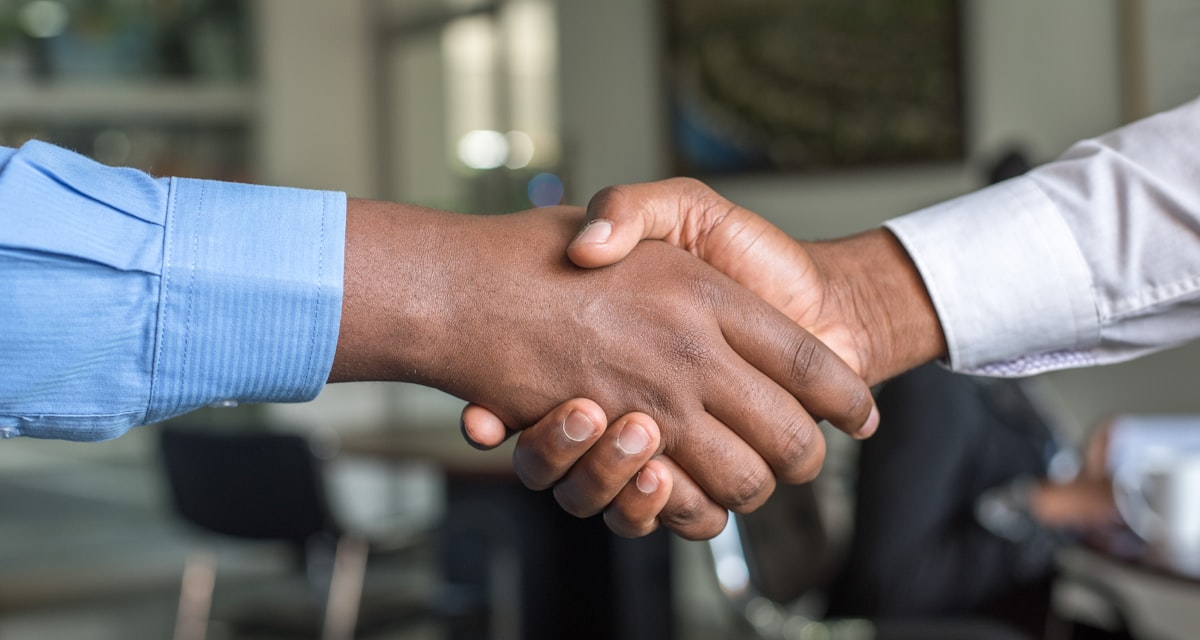 Two business professionals shaking hands after a meeting