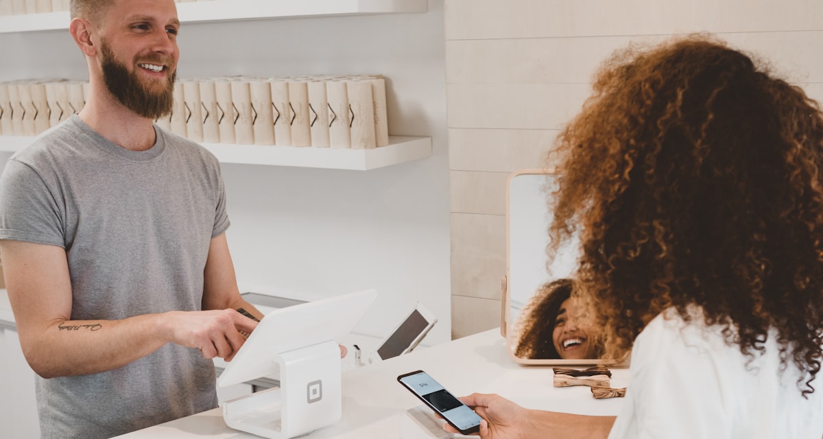 Small business owner taking a customer phone call at the counter